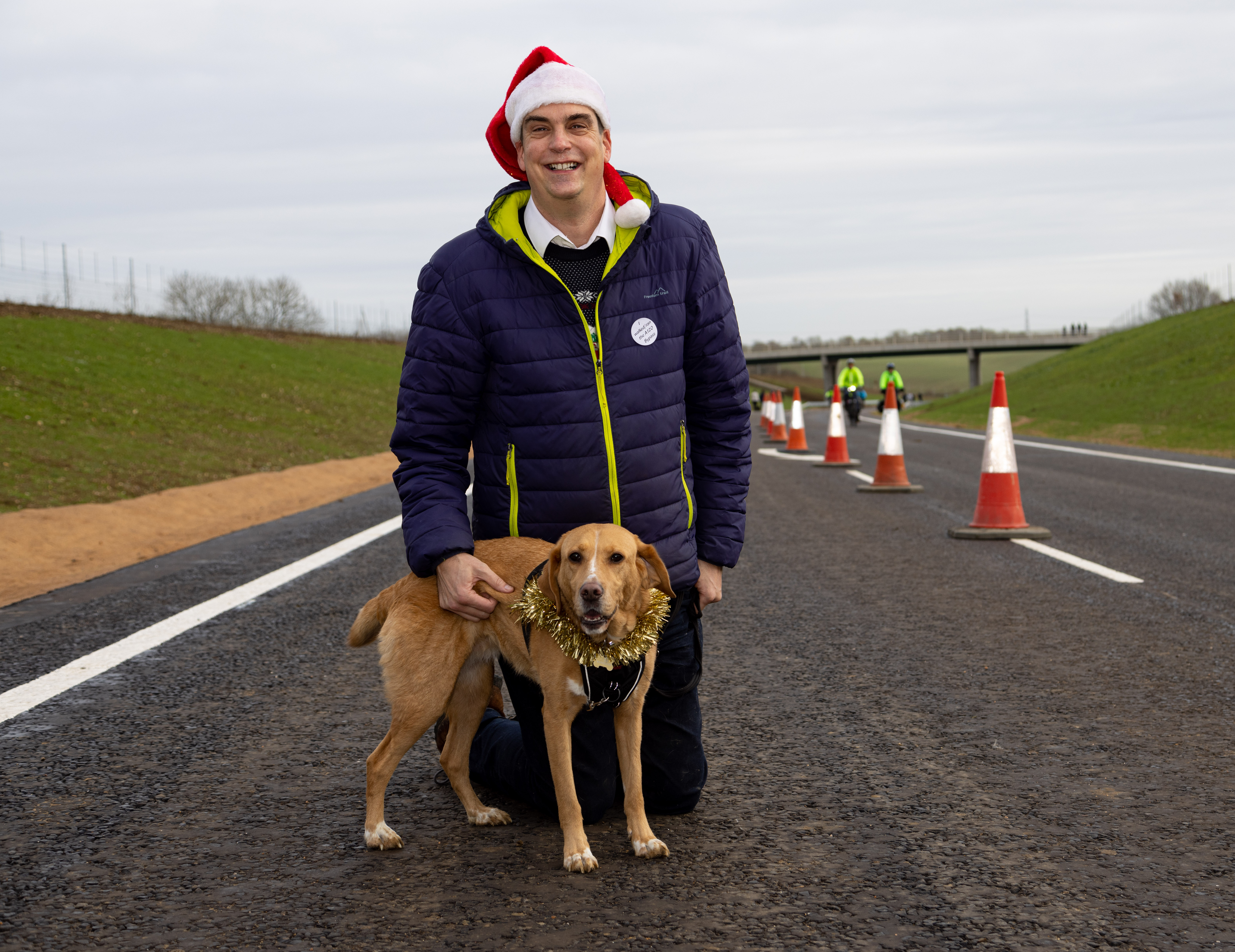 A Santa with dog crosses the bypass