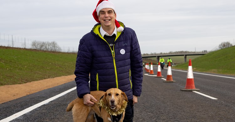 A Santa with dog crosses the bypass