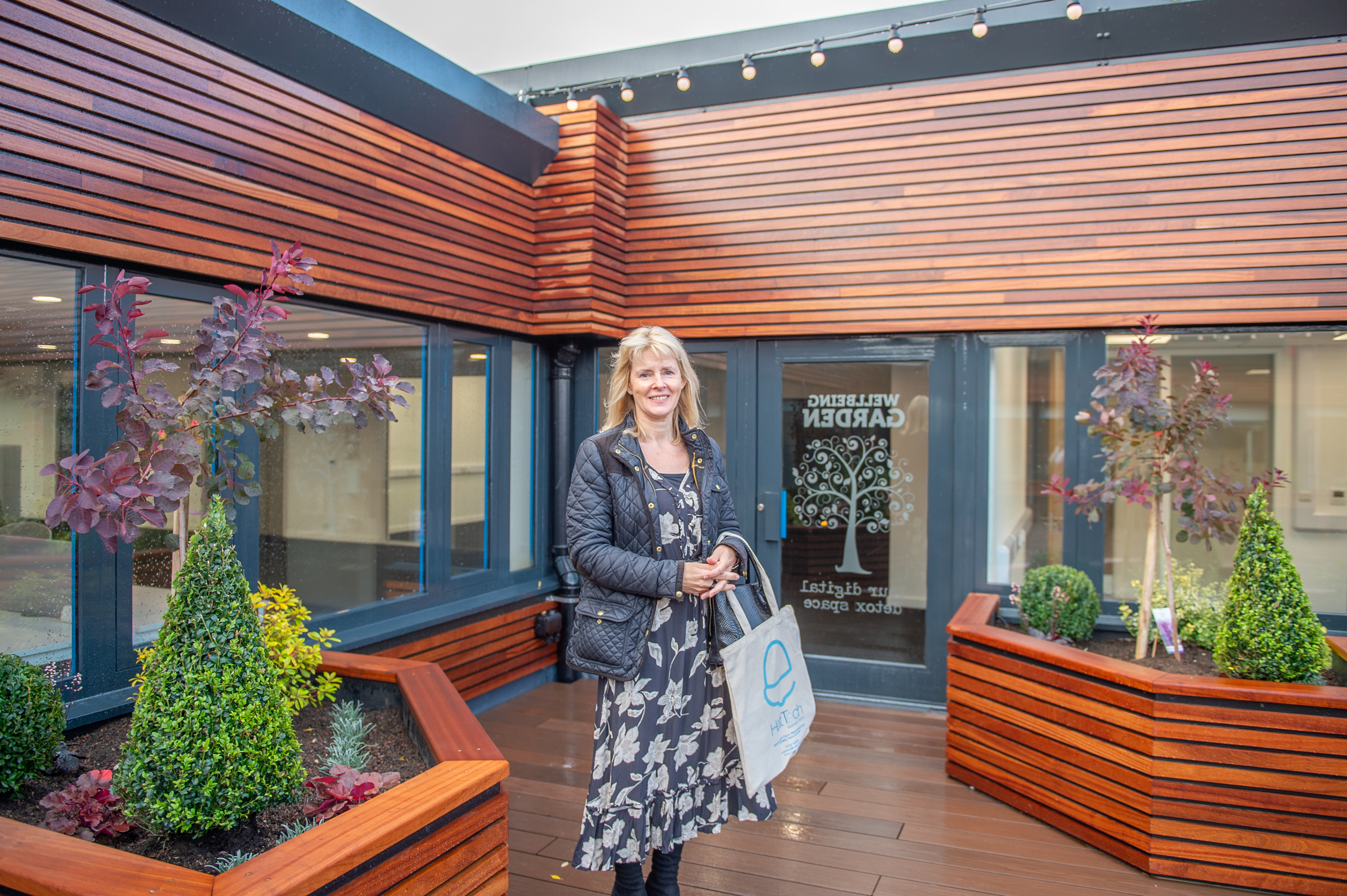 Cllr Fiona Tompson enjoying the wellbeing garden (in the rain!)
