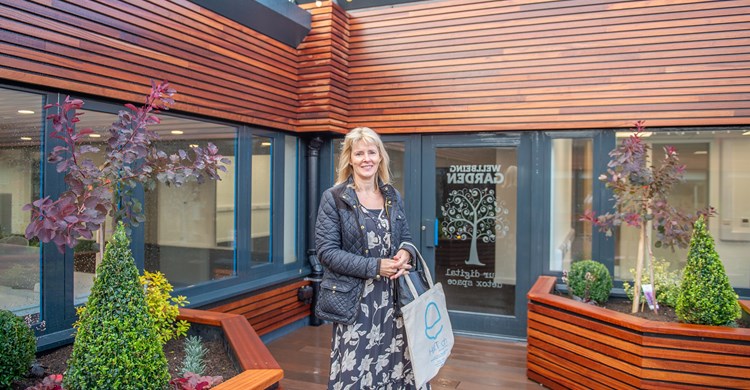 Cllr Fiona Tompson enjoying the wellbeing garden (in the rain!)